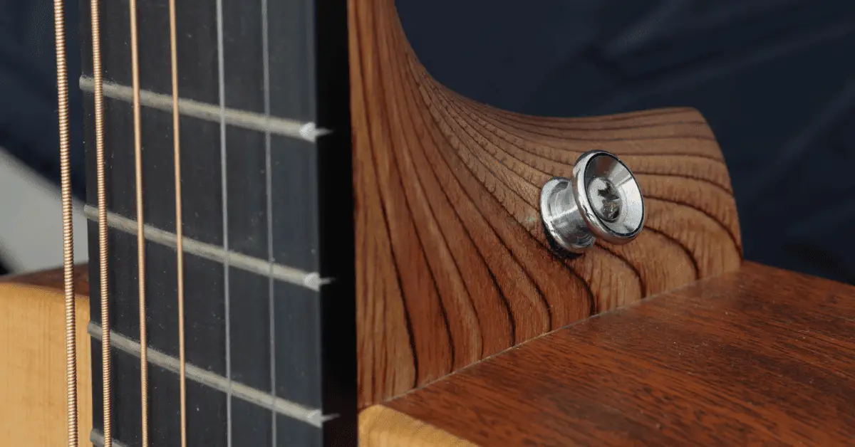 Why Do Acoustic Guitars Only Have One Strap Button? INS.